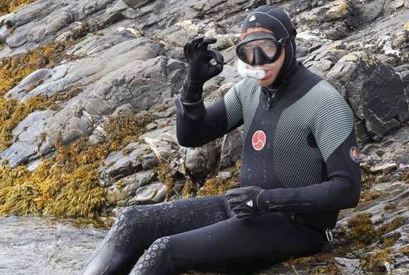 Getting in the sea to inspect salmon nets at Crovie 2015 cropped